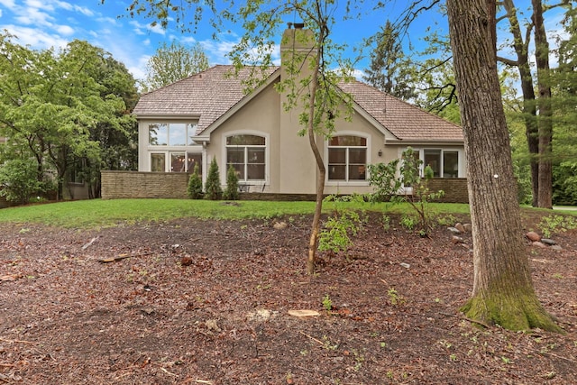 1700 Cornell Ct, Lake Forest, IL 60045 - view of front of house featuring stucco siding, a chimney, and a front lawn