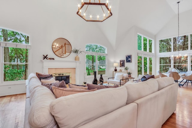 1700 Cornell Ct, Lake Forest, IL 60045 - living area featuring high vaulted ceiling, a chandelier, light wood finished floors, and a glass covered fireplace