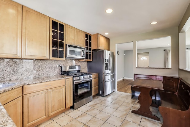 7665 W Victoria St, Chicago, IL 60631 - kitchen featuring appliances with stainless steel finishes, backsplash, light tile patterned flooring, recessed lighting, and glass insert cabinets