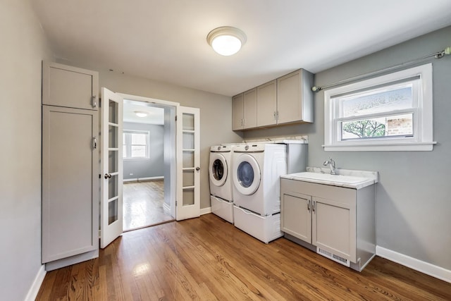 7665 W Victoria St, Chicago, IL 60631 - laundry area featuring washer and clothes dryer, cabinet space, healthy amount of natural light, and light wood finished floors
