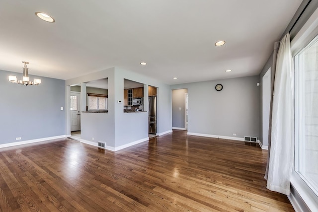 7665 W Victoria St, Chicago, IL 60631 - unfurnished living room with a chandelier, recessed lighting, baseboards, and wood finished floors