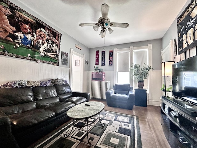 252 Jefferson Ave, Elgin, IL 60120 - living room featuring radiator heating unit, wood finished floors, wainscoting, and ceiling fan