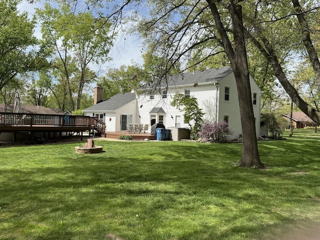 1201 E St, Crete, IL 60417 - rear view of house featuring a deck, a lawn, and a chimney