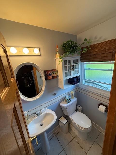 1201 E St, Crete, IL 60417 - half bathroom featuring toilet, tile patterned flooring, and a sink