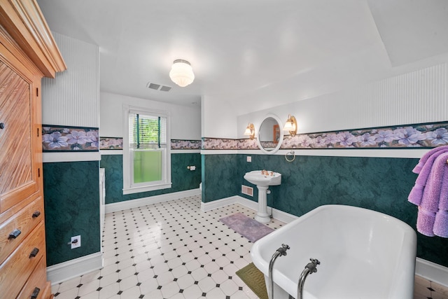 508 Grant St, Earlville, IL 60518 - full bathroom featuring a soaking tub, wainscoting, tile patterned floors, baseboards, and wallpapered walls