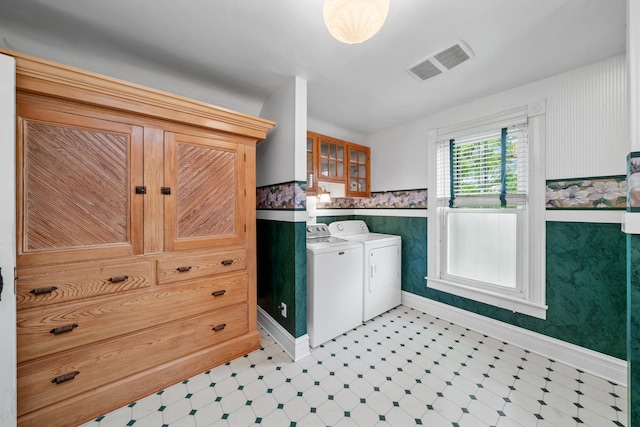 508 Grant St, Earlville, IL 60518 - laundry room featuring washing machine and dryer, light flooring, baseboards, wallpapered walls, and a wainscoted wall