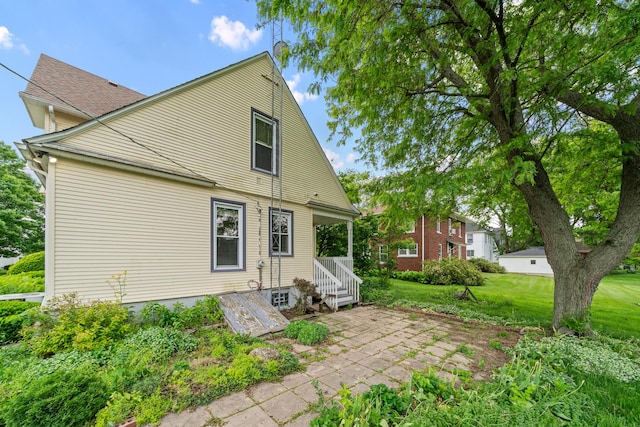 508 Grant St, Earlville, IL 60518 - back of house featuring a lawn and a patio
