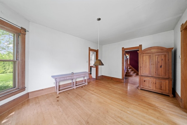 508 Grant St, Earlville, IL 60518 - empty room with healthy amount of natural light, light wood-type flooring, baseboards, and stairs