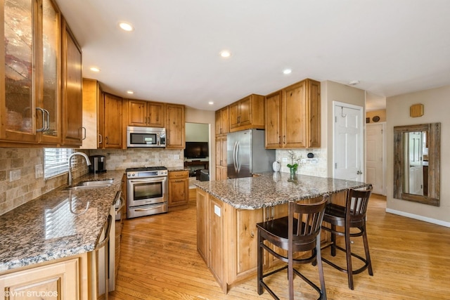 524 Crown Point Dr, Buffalo Grove, IL 60089 - kitchen featuring stainless steel appliances, a sink, light wood-style flooring, tasteful backsplash, and recessed lighting