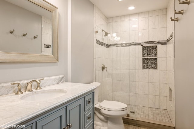 524 Crown Point Dr, Buffalo Grove, IL 60089 - bathroom featuring vanity, toilet, tiled shower, and recessed lighting