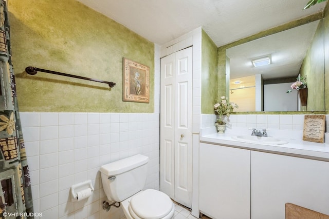 524 Crown Point Dr, Buffalo Grove, IL 60089 - bathroom with toilet, vanity, a closet, tile walls, and tile patterned flooring