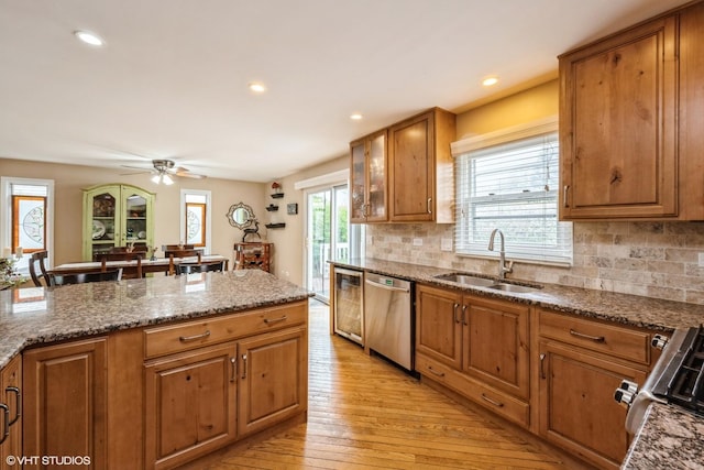 524 Crown Point Dr, Buffalo Grove, IL 60089 - kitchen with a sink, dishwasher, brown cabinets, light wood finished floors, and backsplash