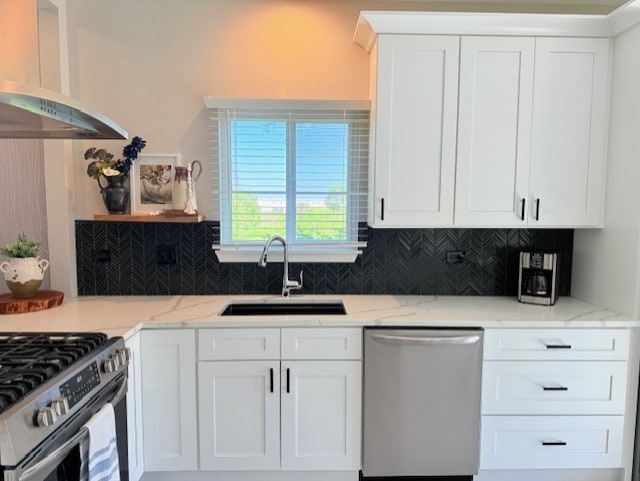 21528 W Douglas Court -, Plainfield, IL 60544 - kitchen featuring stainless steel appliances, a sink, wall chimney exhaust hood, backsplash, and white cabinets