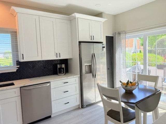 21528 W Douglas Court -, Plainfield, IL 60544 - kitchen with appliances with stainless steel finishes, decorative backsplash, white cabinets, and light wood-type flooring