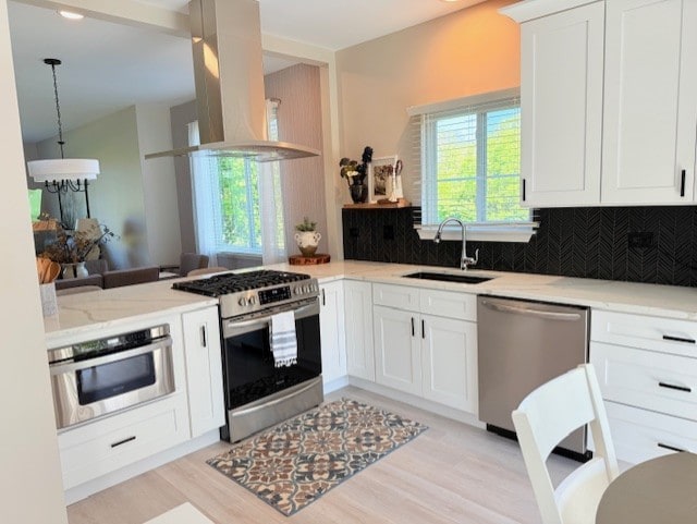21528 W Douglas Court -, Plainfield, IL 60544 - kitchen with stainless steel appliances, island exhaust hood, a sink, decorative backsplash, and light wood finished floors