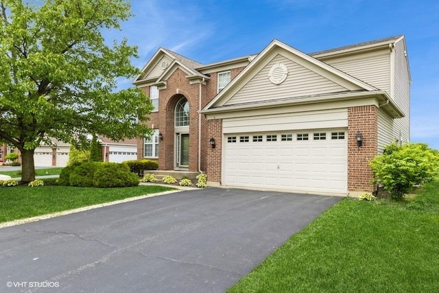 6 Marigold Ln, Algonquin, IL 60102 - traditional-style house featuring driveway, brick siding, a garage, and a front lawn