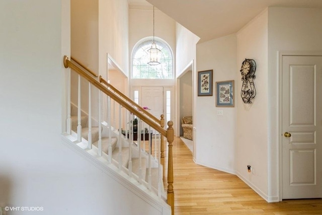 6 Marigold Ln, Algonquin, IL 60102 - stairway featuring a chandelier, wood finished floors, a towering ceiling, and baseboards