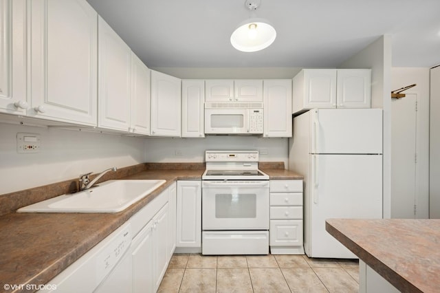 1850 N Clark St Unit 402, Chicago, IL 60614 - kitchen with white appliances, a sink, white cabinets, light tile patterned floors, and dark countertops