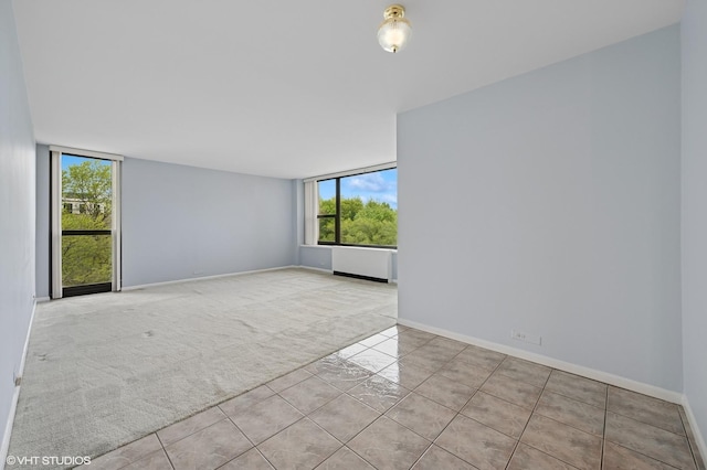 1850 N Clark St Unit 402, Chicago, IL 60614 - tiled empty room with healthy amount of natural light, baseboards, and carpet