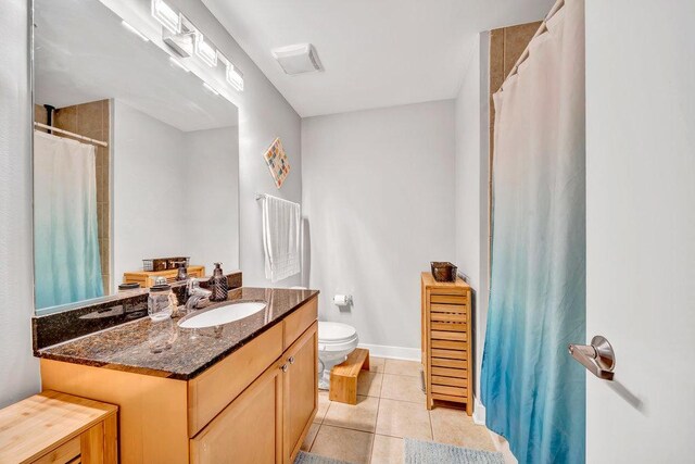 320 E 21st St Unit 412, Chicago, IL 60616 - full bathroom with vanity, toilet, tile patterned floors, baseboards, and a shower with curtain