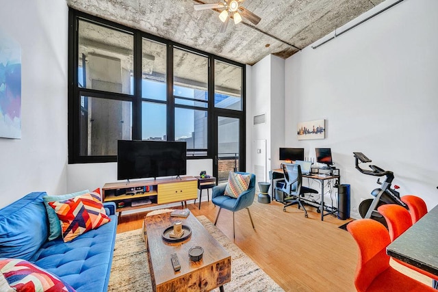 320 E 21st St Unit 412, Chicago, IL 60616 - living room featuring wood finished floors, a ceiling fan, floor to ceiling windows, and an office area