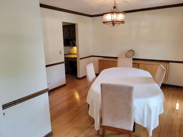 1263 Bainbridge Dr, Naperville, IL 60563 - dining area with light wood-type flooring, crown molding, a chandelier, and baseboards