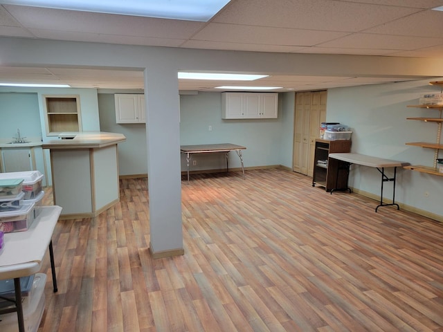 1263 Bainbridge Dr, Naperville, IL 60563 - finished below grade area featuring a sink, light wood-style flooring, baseboards, and a drop ceiling