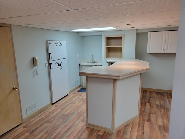 1263 Bainbridge Dr, Naperville, IL 60563 - kitchen featuring freestanding refrigerator, a sink, light wood-style floors, white cabinets, and baseboards