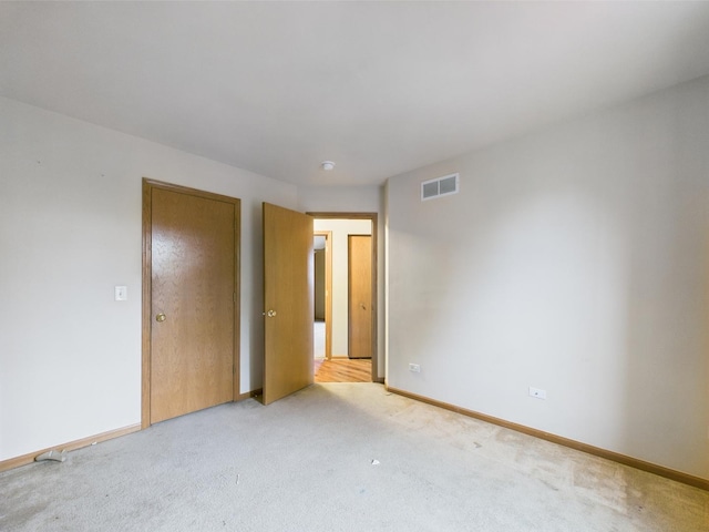 364 Coneflower Dr, Minooka, IL 60447 - unfurnished bedroom with light colored carpet and baseboards
