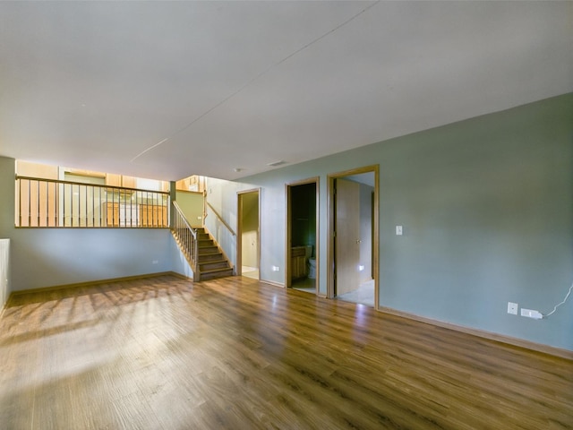 364 Coneflower Dr, Minooka, IL 60447 - empty room with wood finished floors, baseboards, and stairway