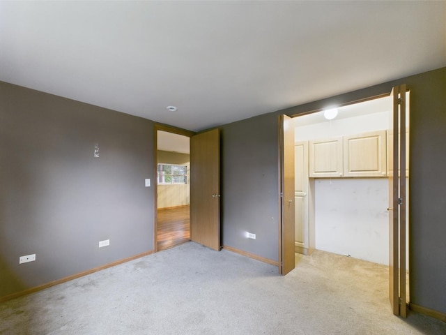 364 Coneflower Dr, Minooka, IL 60447 - unfurnished bedroom featuring light carpet and baseboards