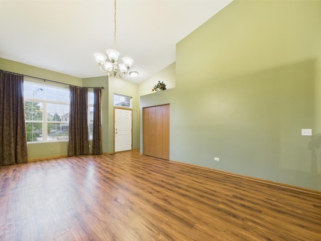 364 Coneflower Dr, Minooka, IL 60447 - spare room featuring a chandelier, wood finished floors, and lofted ceiling
