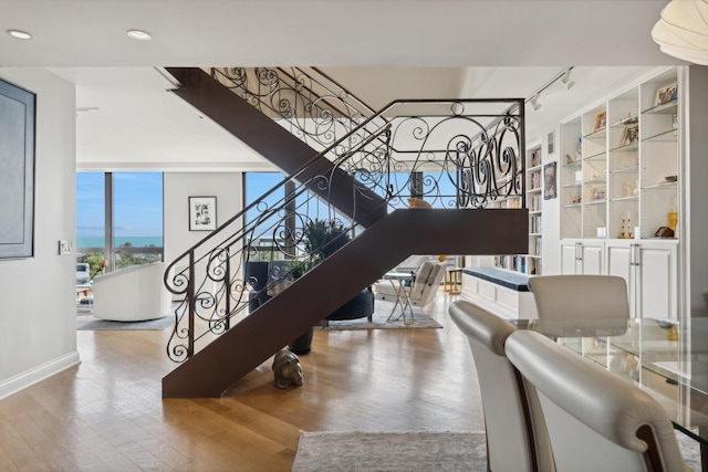2314 N Lincoln Park W Unit 11S, Chicago, IL 60614 - stairs featuring wood finished floors, rail lighting, baseboards, and recessed lighting