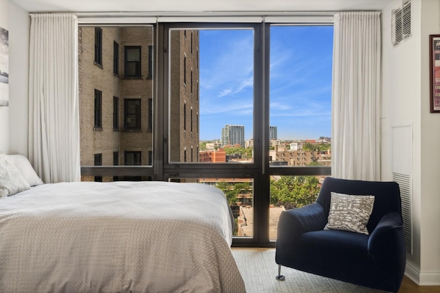2314 N Lincoln Park W Unit 11S, Chicago, IL 60614 - bedroom featuring expansive windows, wood finished floors, and a view of city