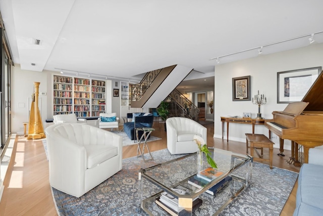 2314 N Lincoln Park W Unit 11S, Chicago, IL 60614 - living room with rail lighting, wood finished floors, stairway, and built in shelves
