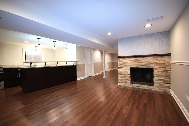 5009 W 79th Pl, Burbank, IL 60459 - unfurnished living room with dark wood-style floors, a fireplace, baseboards, recessed lighting, and a sink