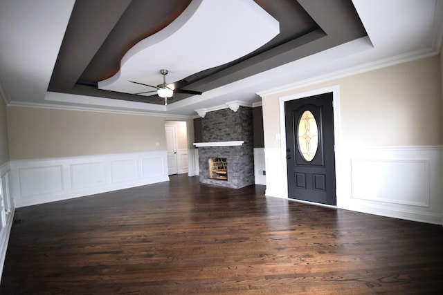 5009 W 79th Pl, Burbank, IL 60459 - unfurnished living room featuring a raised ceiling, ceiling fan, a decorative wall, a wainscoted wall, and a fireplace