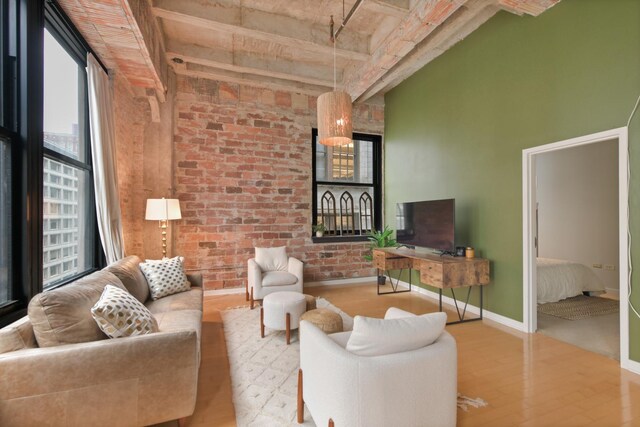20 N State St Unit 805, Chicago, IL 60602 - living area with plenty of natural light, wood finished floors, brick wall, baseboards, and a high ceiling