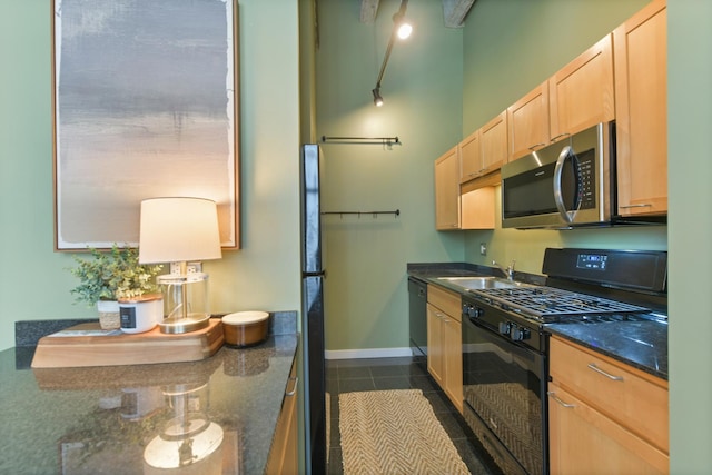 20 N State St Unit 805, Chicago, IL 60602 - kitchen featuring black appliances, light brown cabinetry, a sink, dark tile patterned floors, and dark stone counters