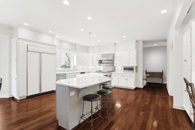 6537 Stockbridge Ln, Long Grove, IL 60047 - kitchen featuring wall chimney range hood, white cabinets, tasteful backsplash, built in appliances, and dark wood finished floors