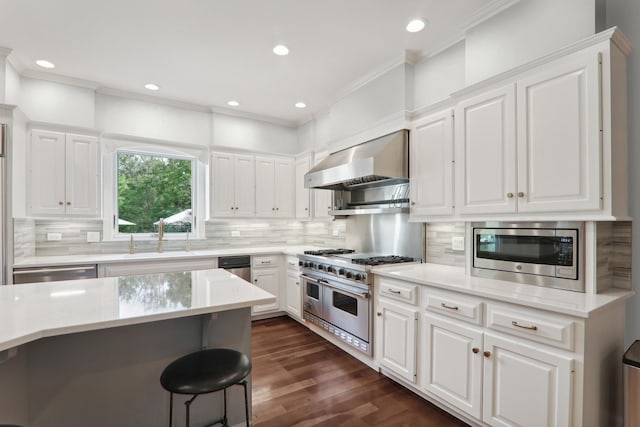 6537 Stockbridge Ln, Long Grove, IL 60047 - kitchen with appliances with stainless steel finishes, wall chimney range hood, a sink, ornamental molding, and white cabinetry