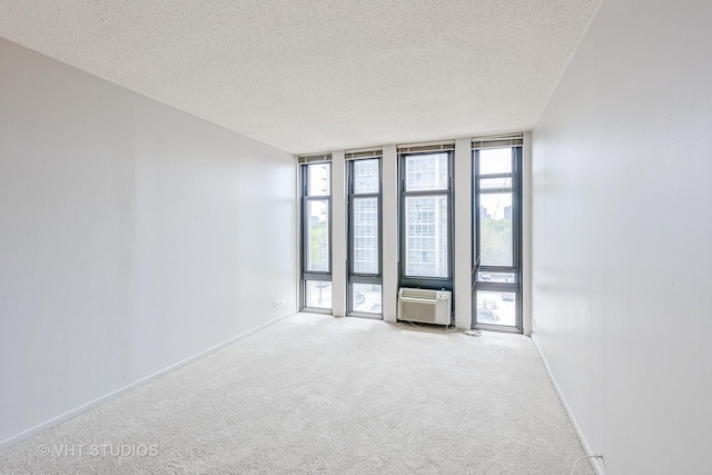 6700 S S Shore Dr Unit 5E, Chicago, IL 60649 - empty room featuring expansive windows, a textured ceiling, carpet, baseboards, and cooling unit