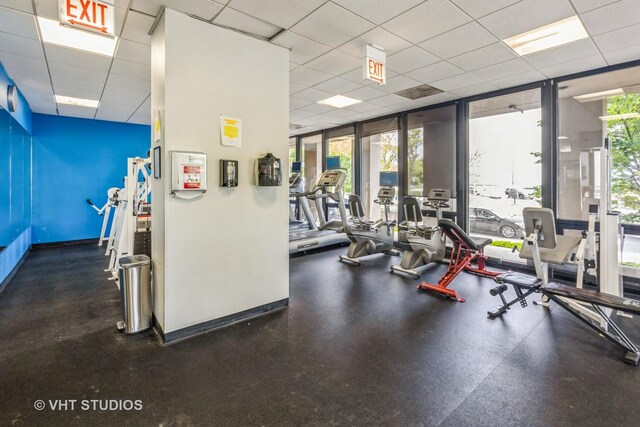 6700 S S Shore Dr Unit 5E, Chicago, IL 60649 - exercise room featuring a drop ceiling, floor to ceiling windows, and baseboards