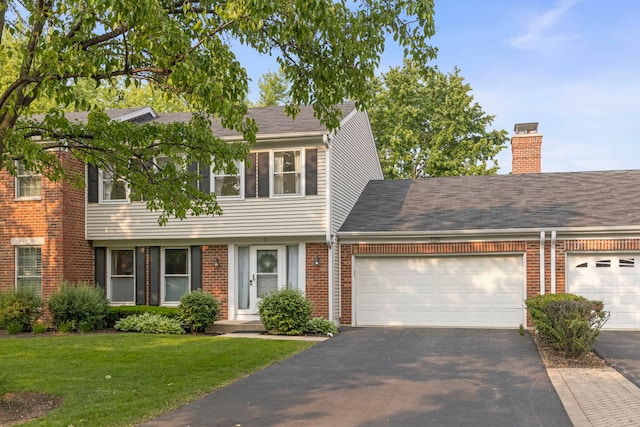 1209 W Bauer Rd, Naperville, IL 60563 - view of front of home featuring asphalt driveway, brick siding, a front yard, an attached garage, and a chimney