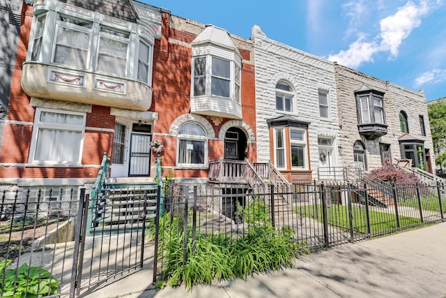 4728 S Evans Ave, Chicago, IL 60615 - townhome / multi-family property featuring a fenced front yard, a gate, and brick siding