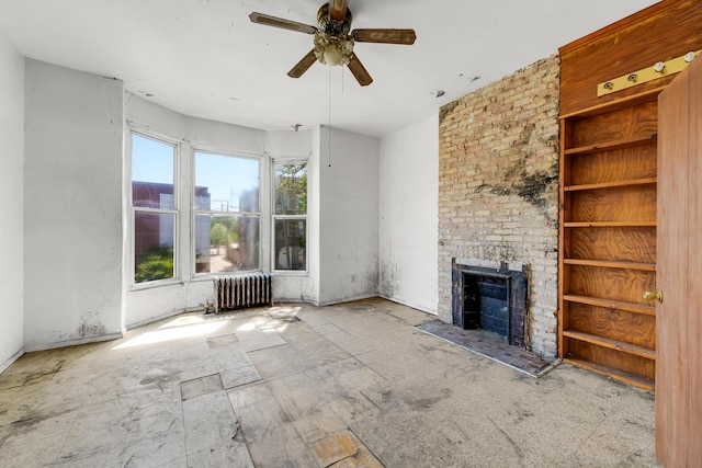 4728 S Evans Ave, Chicago, IL 60615 - unfurnished living room with radiator heating unit, ceiling fan, and a fireplace