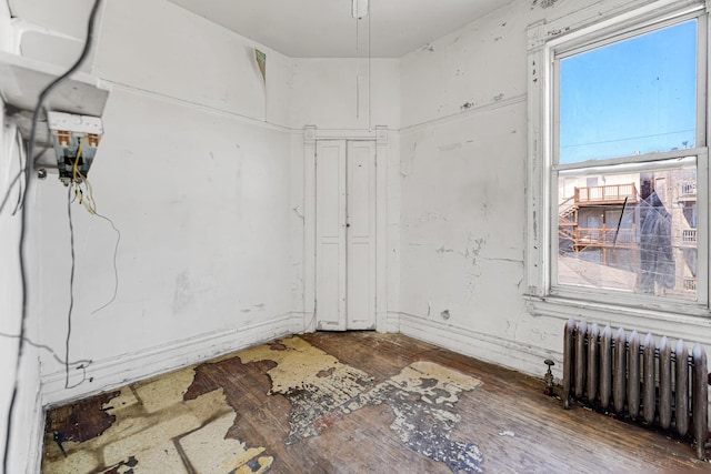 4728 S Evans Ave, Chicago, IL 60615 - unfurnished room featuring radiator heating unit and wood finished floors