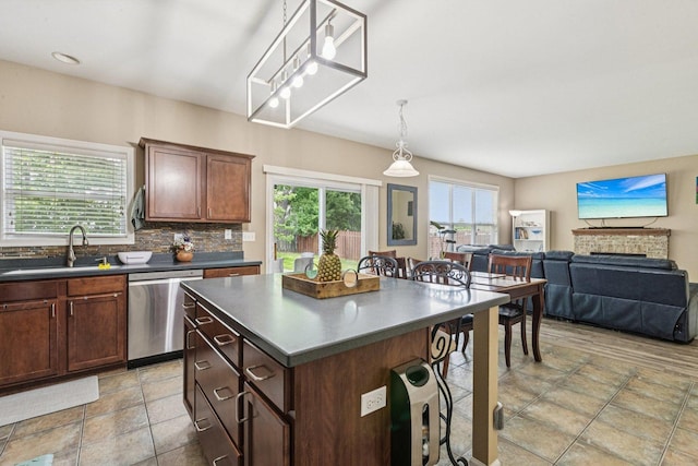 1885 W Greenleaf Ct, Round Lake, IL 60073 - kitchen featuring dishwasher, a sink, dark countertops, a kitchen breakfast bar, and healthy amount of natural light