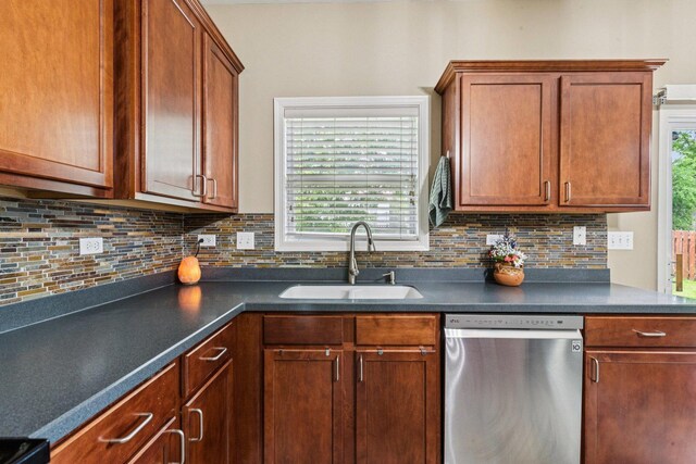 1885 W Greenleaf Ct, Round Lake, IL 60073 - kitchen featuring dishwasher, a sink, dark countertops, backsplash, and brown cabinetry