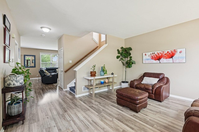 1885 W Greenleaf Ct, Round Lake, IL 60073 - living room with light wood-style floors, stairs, and baseboards